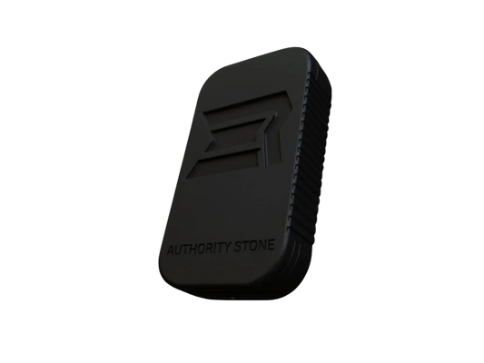 Elite Regiment Authority Stone™ solid cologne in matte black zinc alloy casing with engraved ER logo, premium men’s refillable fragrance accessory